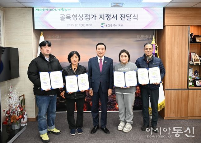 박천동 북구청장이 9일 구청장실에서 골목형상점가로 추가 지정된 상인회에 지정서를 전달한 후 기념촬영을 하고 있다.